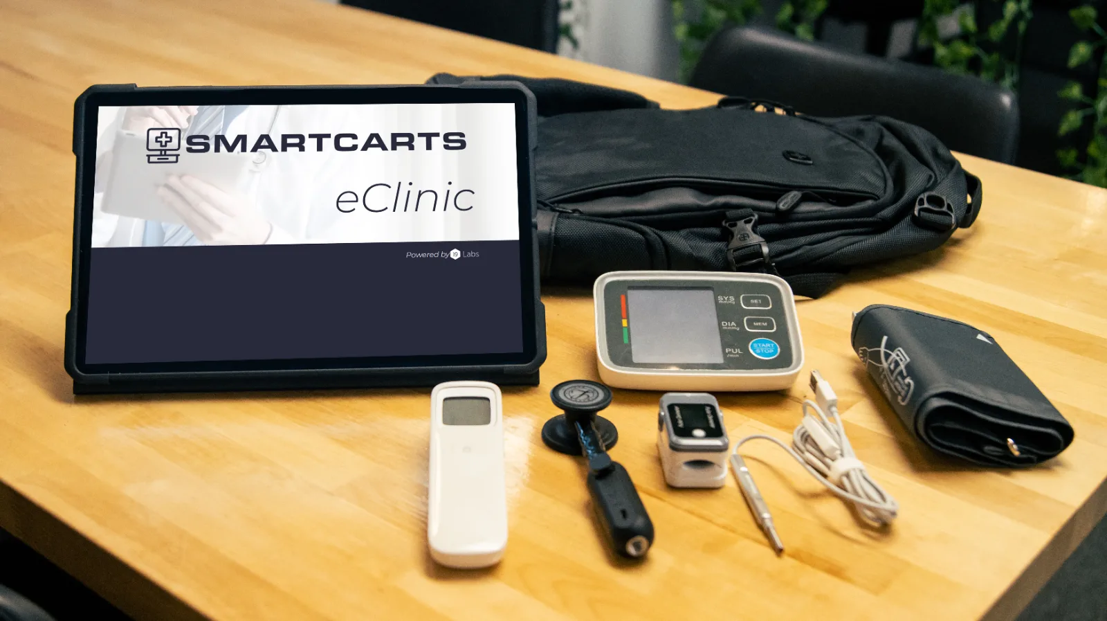 The SmartCarts device kit: tablet running eClinic with a blood pressure monitor, digital stethoscope, pulse oximeter, and exam camera